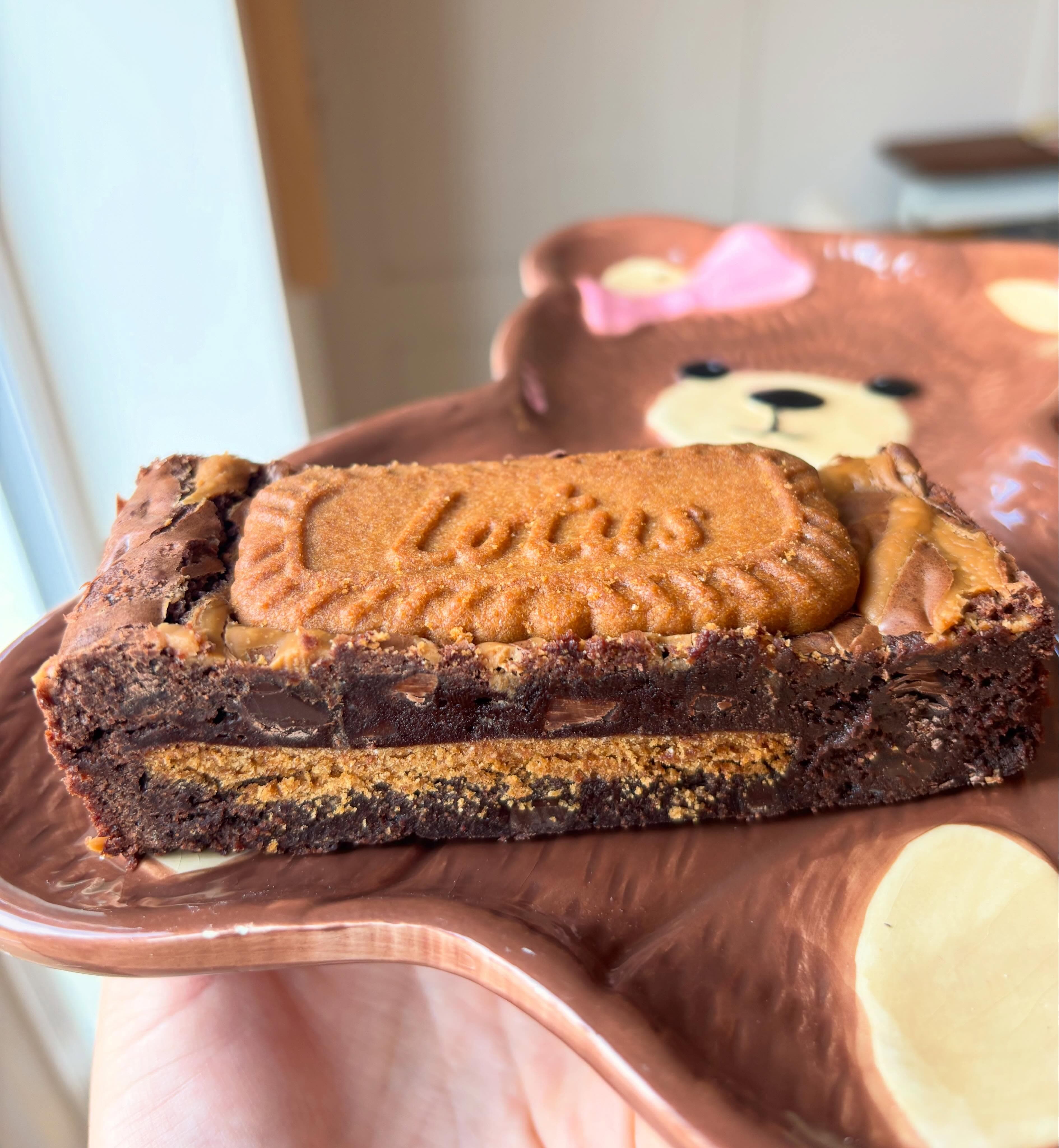 Biscoff brownie slice topped with a Lotus biscuit