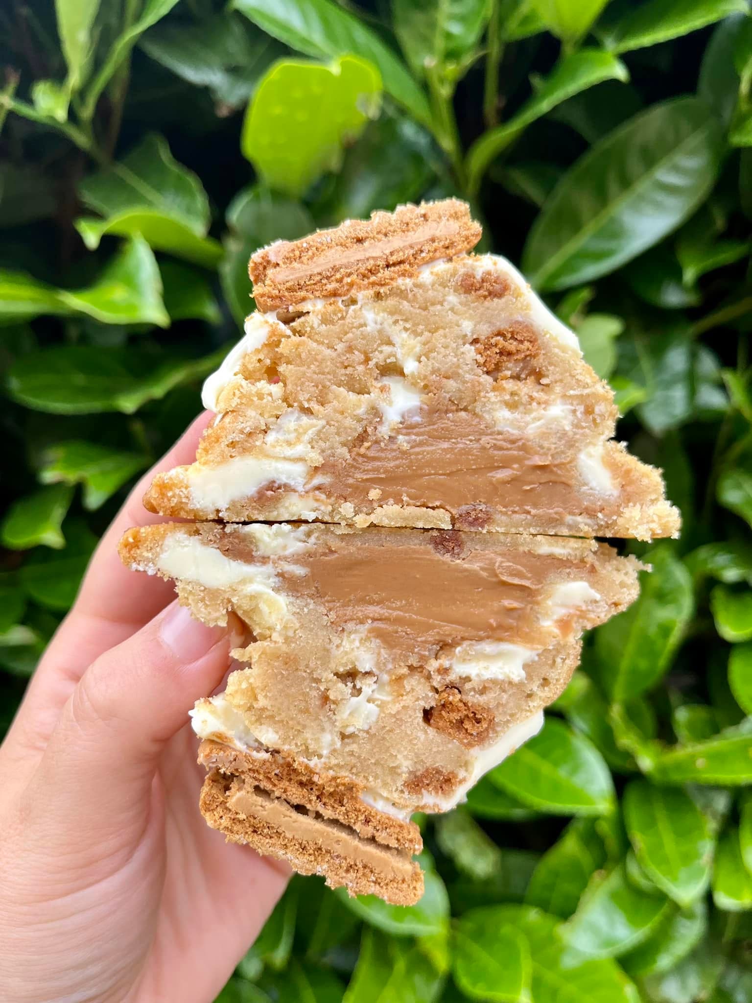 Biscoff deluxe stuffed cookie cut open with Biscoff spread