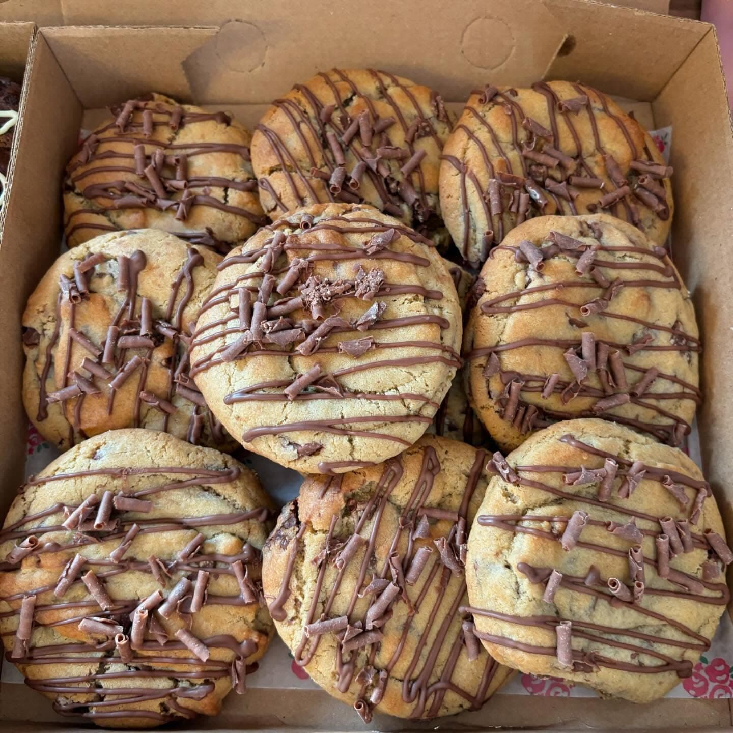 Box of Nutella stuffed cookies with chocolate drizzle