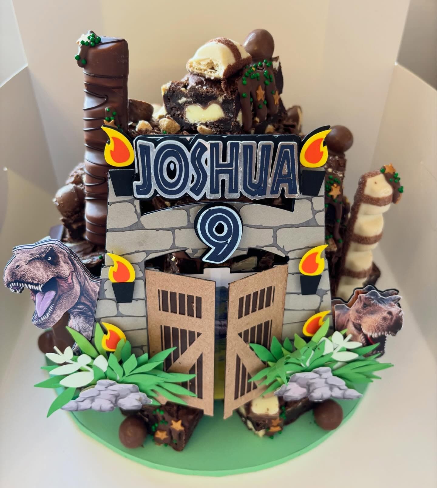 Dinosaur themed brownie stack celebration cake with decorated toppers