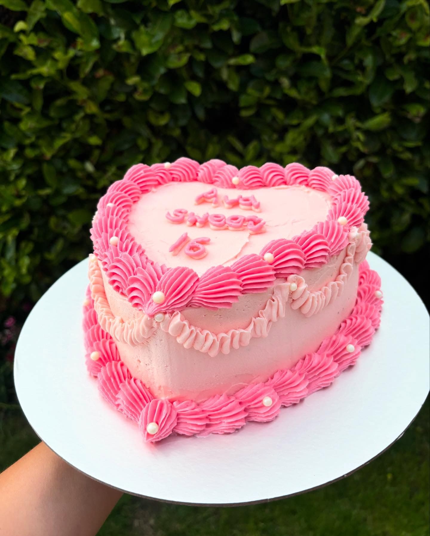 Pink heart shaped cake with piped shell border