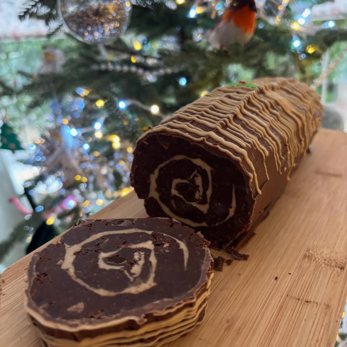 Sliced Christmas brownie yule log showing the swirled centre