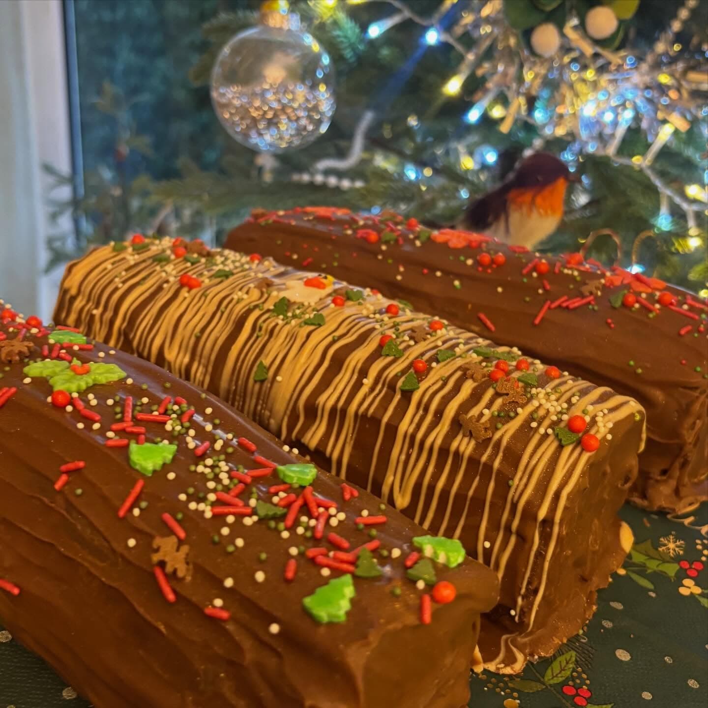 Christmas brownie yule logs decorated with festive sprinkles