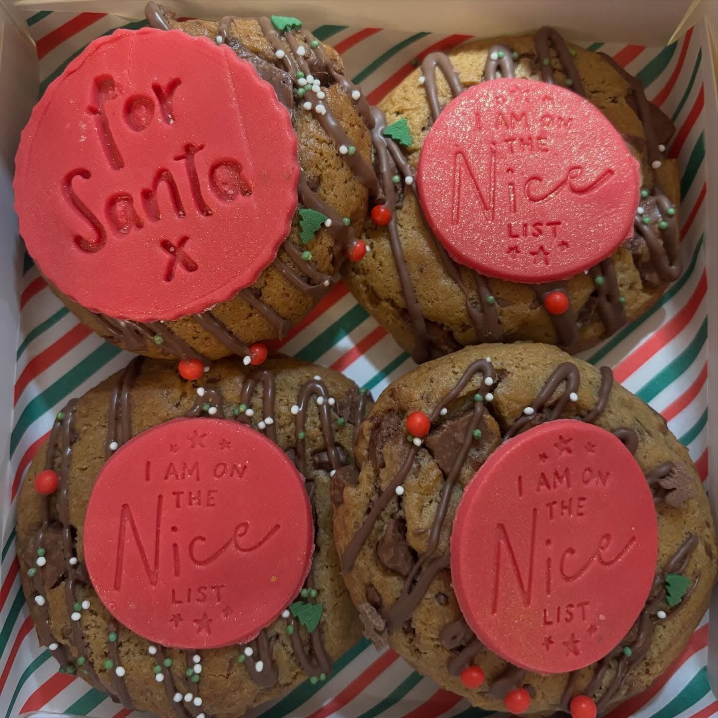 Christmas cookies with red Santa and nice-list fondant toppers