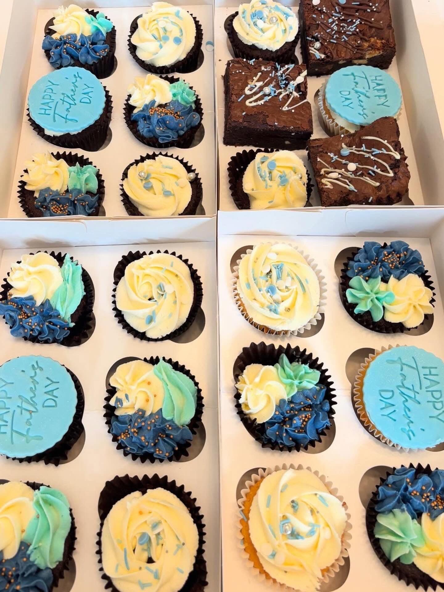 Several Father's Day cupcake and brownie boxes with blue decorations