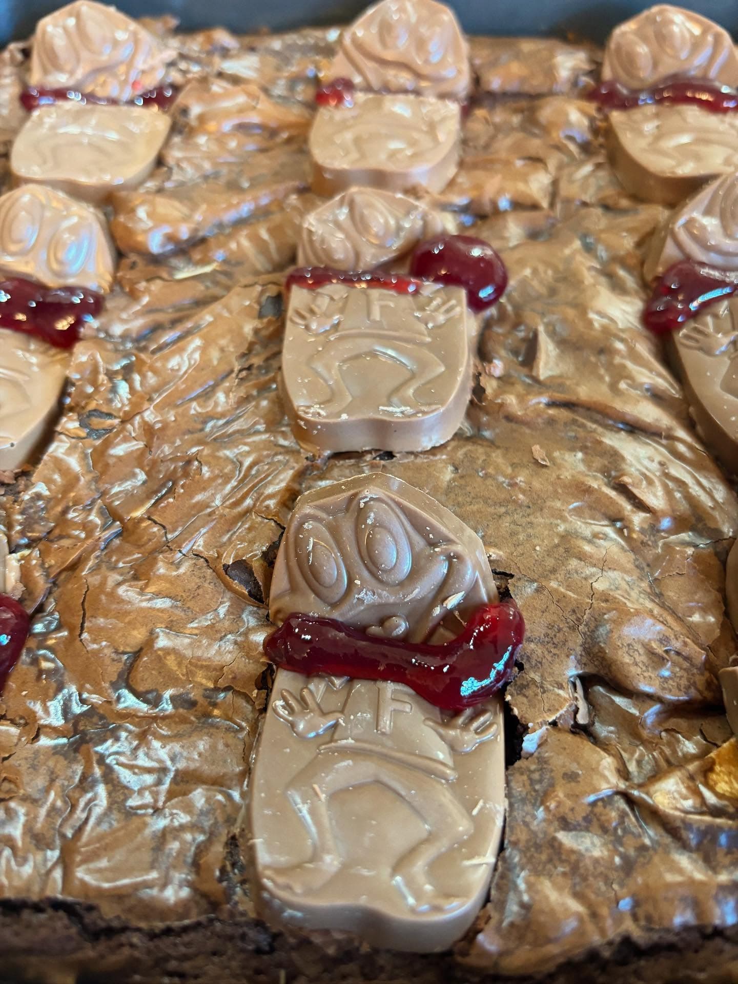 Halloween brownies topped with chocolate character pieces and red jam