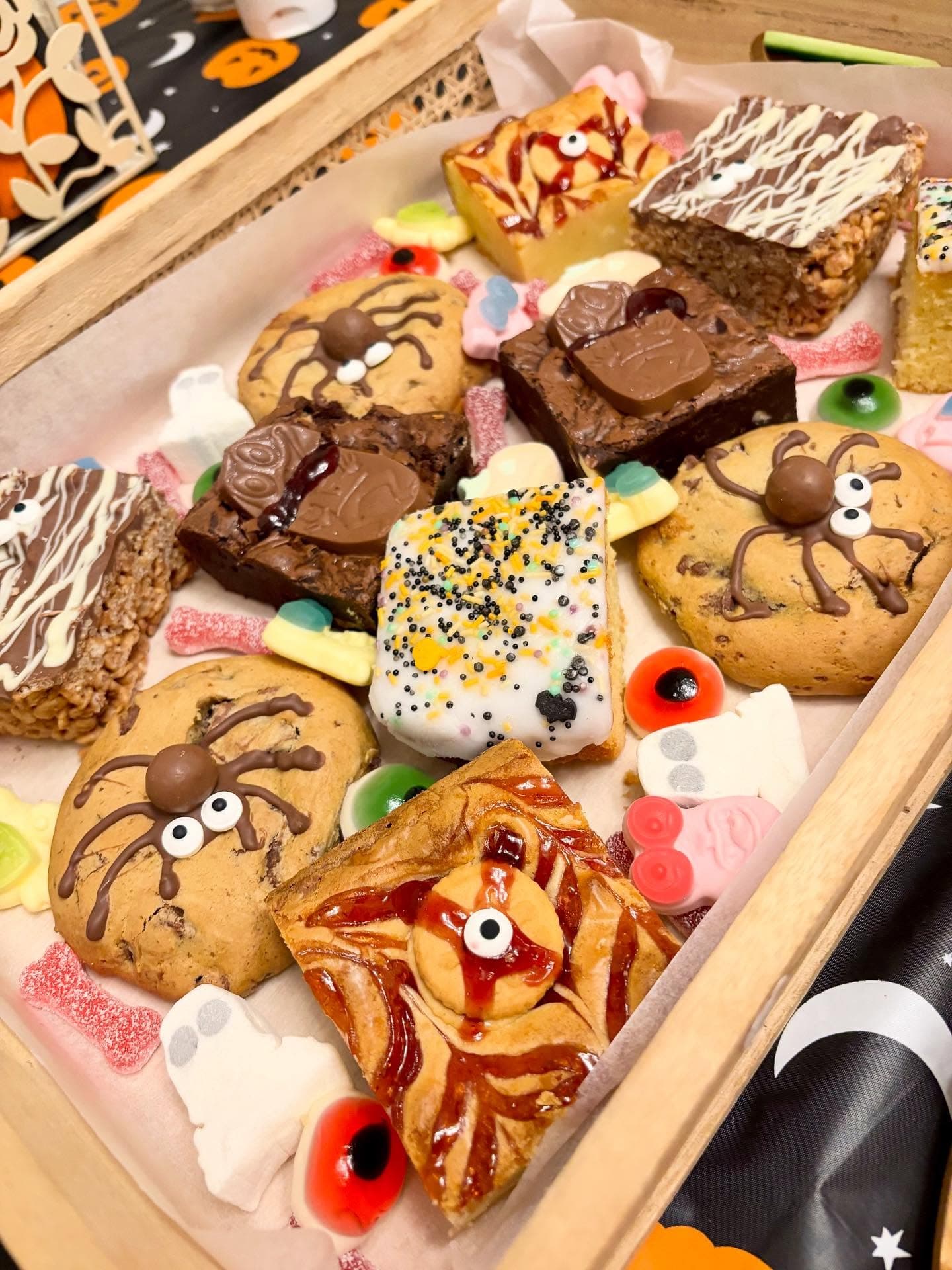 Halloween treat box filled with decorated cookies, brownies and sweets