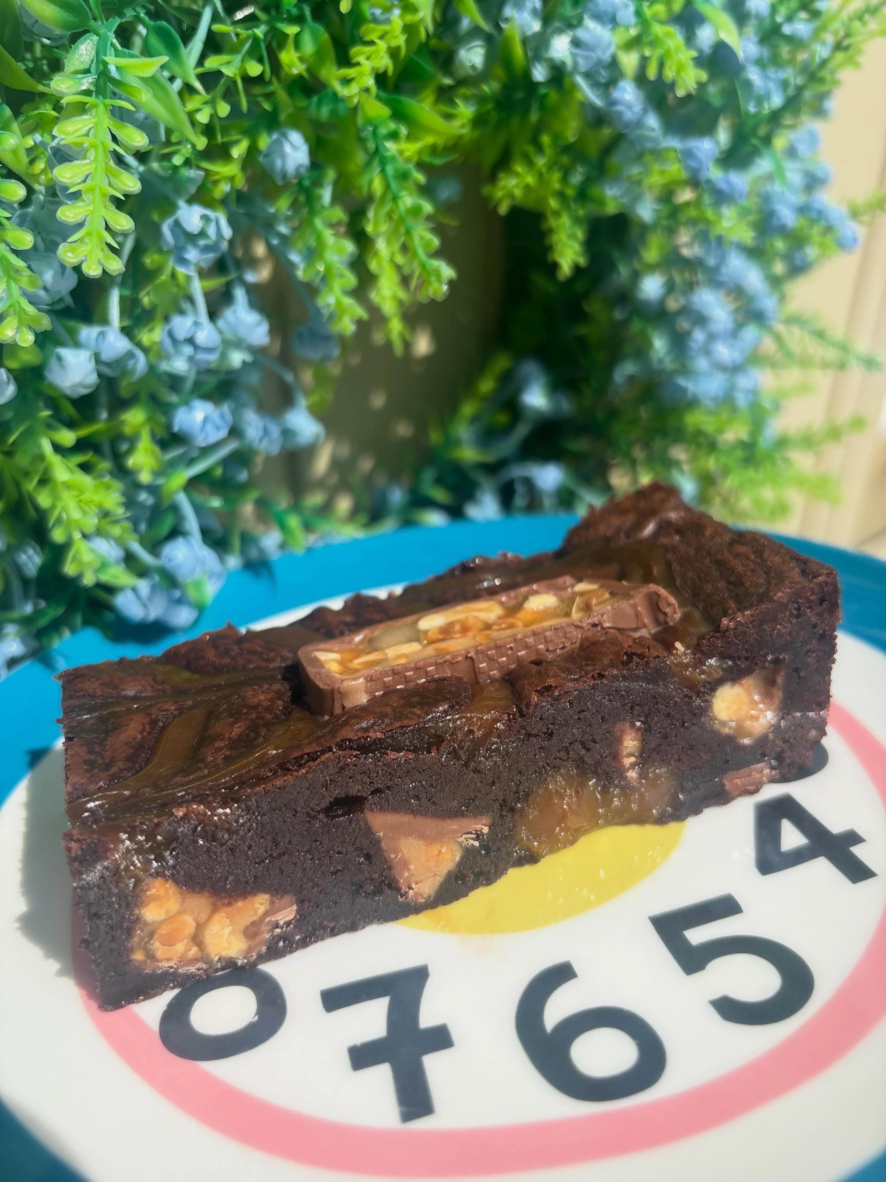 Snickers brownie slice with caramel and peanuts