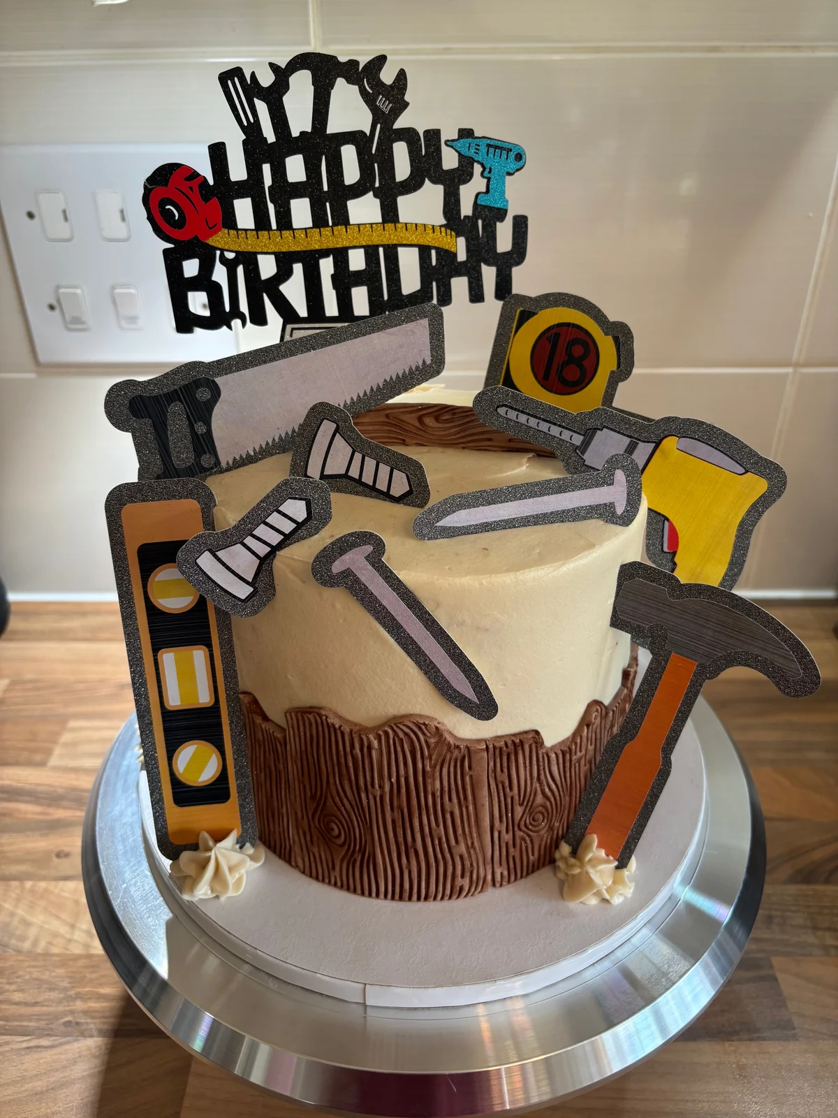 Woodworking birthday cake with wood grain icing and colourful tool toppers